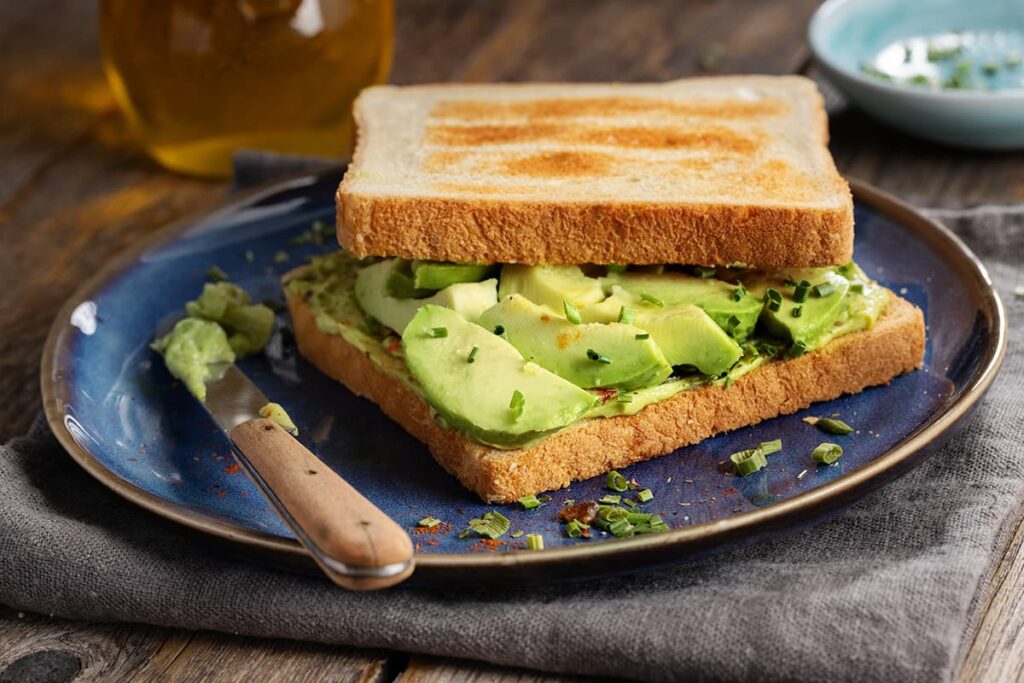 Sandwich met gepureerde avocado en kruiden